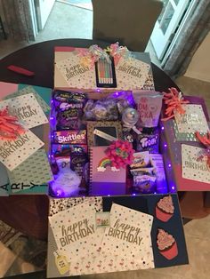 a table topped with lots of birthday cards and gift boxes on top of each other