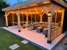 an outdoor living area with patio furniture and lights