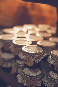 there are many jars with lace doily on the top and one is filled with coins