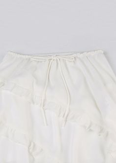 Beautiful WhiteRuffled Asymmetrical Lace Up Cotton Skirt SummerFabric: Cotton BlendedSize & Fit: This garment fits true to size.Length: Size S measures 30.615"from waist to hem.Waist:Fitted - elastic waist allows stretch Hip: Loosely Fitted. room for hips. Hand Wash Cold. Solid Ruffles Mini Skirt For Beach, Asymmetrical Ruffle Skirt For Beach, White Summer Skirt With Asymmetrical Hem, White Asymmetrical Hem Skirt For Summer, Asymmetrical Ruffled Beach Skirt, Spring Ruffled Asymmetrical Skirt, Brunch Skirt With Ruffles, Beach Asymmetrical Skirt With Ruffles, Elegant Asymmetrical Hem Mini Skirt For Summer