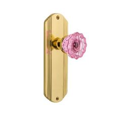 an image of a pink door handle on a gold doorknobl with floral design