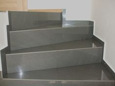 a set of stairs made out of grey marble