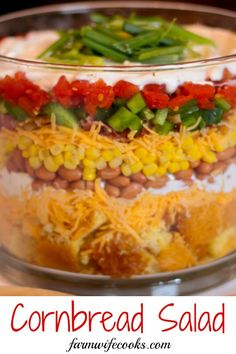 cornbread salad in a glass bowl with green beans, red peppers, and cheese