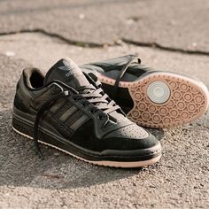 a pair of black shoes sitting on the ground