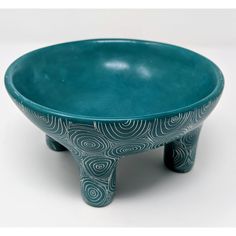 a blue bowl sitting on top of a white table