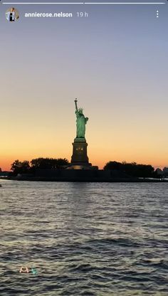 the statue of liberty at sunset from across the water