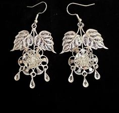 Beautiful vintage sterling silver filigree floral chandelier earrings  They measure: 2 inches long with a 2 1/2 inch drop counting the ear wires by 1 1/4 inch wide and weigh 8.8 grams combined  Screw backs have been replaced with sterling silver ear wires to accommodate pierced ears Silver Dangle Chandelier Earrings With Intricate Design, Victorian Filigree Chandelier Dangle Earrings, Victorian Silver Dangle Chandelier Earrings, Silver Victorian Dangle Chandelier Earrings, Silver Chandelier Drop Earrings With Intricate Design, Silver Intricate Chandelier Drop Earrings, Silver Chandelier Earrings With Intricate Design, Handmade Silver Victorian Chandelier Earrings, Traditional Filigree Chandelier Earrings