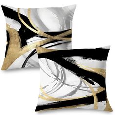 two black and white pillows with gold lines on the front, one has an abstract design