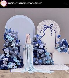 a blue and white wedding set up with flowers