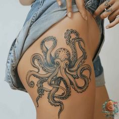 an octopus tattoo on the back of a woman's thigh, showing it's intricate