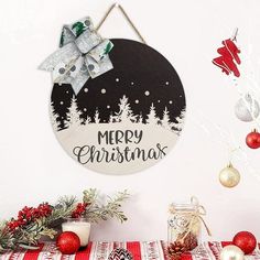 a merry christmas sign hanging from the side of a wall next to ornaments and decorations