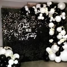 black and white balloons are arranged in the shape of an arch with words that read, do us party