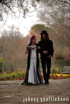 a man and woman dressed up in wedding attire