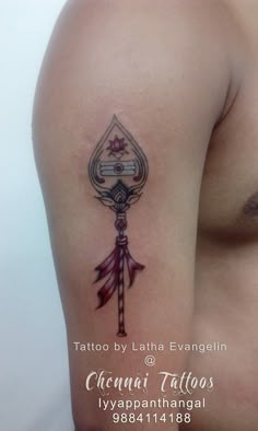 a tattoo on the back of a woman's arm with an arrow and key