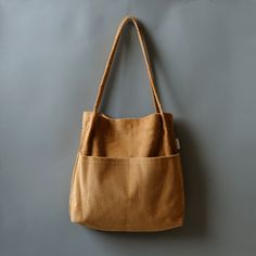 More Colors:  https://www.etsy.com/shop/Bokzim?search_query=double+pocket ------------------------------------------------------- Double Pocket Corduroy Tote Bag 👉 F E A T U R E S - Soft corduroy fabric  - Multi pockets  - 13" laptop fit in  - Magnetic closure - Handmade in Korea  [Large Capacity]: big enough to carry a 13" laptop and an A4 ring binder  [Multi compartments]: TWO exterior pockets and ONE inner pocket help organize your essentials effectively. [Material]: Feel the difference. Soft corduroy fabric is used. No smell of bad chemicals.  📏 D I M E N S I O N S Length: 13.3" (34cm) Height: 14.5" (37cm) Depth: 3.1" (8cm) Drop Length: 12.6" (32cm) Handmade in Korea  . Corduroy Canvas Shoulder Bag With Pockets, Corduroy Shoulder Canvas Bag With Pockets, Corduroy Rectangular Shoulder Bag With Pockets, School Corduroy Bag With Pockets, School Bag With Pockets In Corduroy, Daily Use Corduroy Shoulder Bag With Pockets, Rectangular Corduroy Shoulder Bag With Pockets, Corduroy Tote Bag For School, Daily Use Corduroy Canvas Bag With Pockets