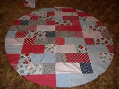 a round patchwork table top sitting on the floor