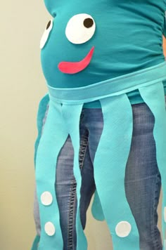 a pregnant woman wearing an octopus costume with her belly wrapped around the waist and legs