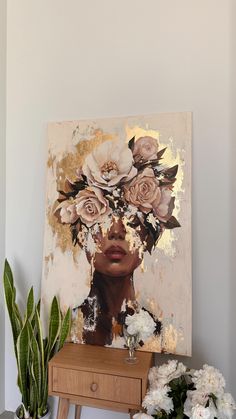 a painting with flowers on it next to a table