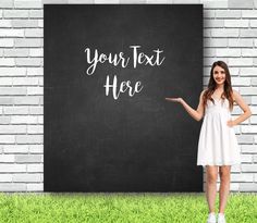 a young woman standing in front of a chalkboard with the words your text here written on it