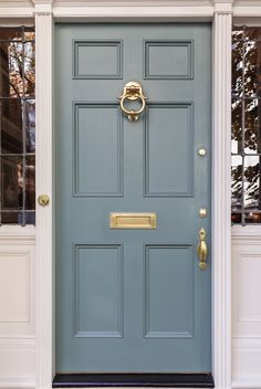 a blue front door with gold handles