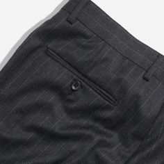 Complete your look with The Lakeshore Chalk Stripe Pants in Charcoal. Made from 100% wool, these pants feature a slim fit through the hips and thighs, with a tapered leg opening for a sleek finish. The arrow shape extension tab at the waistband adds a modern touch, while the lining to the knee ensures comfort even in warmer months. | Men's Tie Bar: The Lakeshore Chalk Stripe Pants - 31 30 31 / 30, In Dark Grey, Wool, Striped Fitted Pinstripe Dress Pants, Pinstripe Tapered Leg Business Bottoms, Semi-formal Custom Fit Pants With Welt Pockets, Wool Tapered Leg Bottoms For Business Casual, Classic Fitted Pinstripe Pants, Tailored Wool Straight Leg Bottoms, Business Casual Wool Tapered Leg Bottoms, Custom Fit Pants With Welt Pockets For Business Casual, Business Casual Wool Bottoms With Tapered Leg