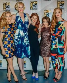 four women in dresses posing for the camera at comic con anaheim 2012, one woman has her arm around another woman's shoulder