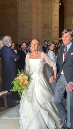 the bride and groom are walking down the aisle after their wedding ceremony at san francisco city hall