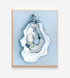 an abstract painting with white and blue colors on a light blue background, framed in wood