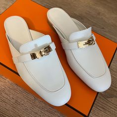 Brand New Hermes Oz Mule In White, Size 35 Eu (Size 5 Us) Never Worn. New In The Box. Natural Leather Sole Natural Leather Heel Permabrass-Plated Buckle White Goatskin Insole And Lining Hermes White Mules, Hermes Esmee Mule, Hermes Oz Mule, Hermes Heels, White Mules, Hermes Shoes, Walker Boots, Fit N Flare Dress, Rain And Snow Boots