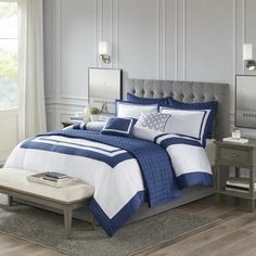 a blue and white bed in a bedroom