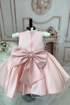 For a vision of chic elegance, look no further than our Glamorous Satin Dress for Little Girls. Available in either a regal white or stunning pink color, this high-quality, one-of-a-kind satin dress is perfect for any formal event or special occasion. The silhouette is classic, with a fitted bodice and a fluffy skirt that swirls delightfully at every twirl. Delicate patterns are beautifully embroidered on the bodice, giving an additional touch of sophistication. Each and every satin dress is met Princess Baptism Dress With Bow, Princess Style Baptism Dress With Bow For Formal Occasions, Pink Princess Dress For Formal Occasions, Pink Princess Style Formal Dress, Princess Style Satin Ball Gown Dresses, Sleeveless Pink Pageant Dress For Wedding, Fitted Baptism Dress With Bow, Pink Fitted Pageant Dress For Wedding, Elegant Fitted Pink Baptism Dress