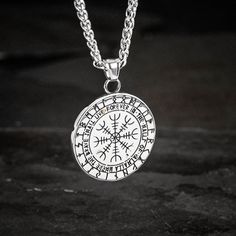 This stainless steel necklace is perfect for those who want to add a little bit of mythology to their wardrobe. The shield style pendant features the mythical serpent Jormungand, encircling a Valknut symbol. Whether you're dressing up for a day at the office or dressing down for a night out on the town, this necklace is sure to make a statement. Also features a Helm of Awe on the reverse with the inscription: "The brave shall live forever in the halls of Valhalla" Pendant is approx. 1.5" across Symbolic Stainless Steel Medallion Jewelry, Symbolic Silver Medallion Necklace, Viking Style Stainless Steel Necklace For Gift, Symbolic Silver Tarnish Resistant Medallion Necklace, Symbolic Silver Medallion Necklace Tarnish Resistant, Symbolic Silver Tarnish-resistant Medallion Necklace, Viking Style Engraved Metal Necklaces, Medieval Silver Round Pendant Necklace, Silver Pendant Necklace For Outdoor