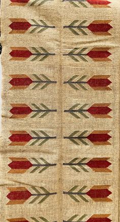 an old navajo rug with red, green and brown designs on it's sides