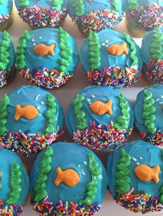 cupcakes decorated with blue frosting and colorful sprinkles