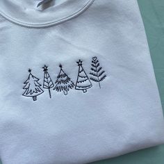 Christmas Tree Embroidered Sweatshirt  Thread colour can be personalised  50 Cotton 50 Polyester Embroidered Cotton Christmas Sweatshirt, White Embroidered Sweatshirt For Winter, Christmas White Embroidered Tops, White Tops With Custom Embroidery For Christmas, Embroidered Christmas Holiday Tops, Embroidered Crew Neck Winter Tops, Holiday Embroidered Tops As Gift, White T-shirt With Embroidered Text For Winter, Holiday Cotton Embroidered Tops