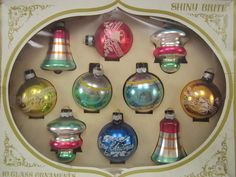 an assortment of glass christmas ornaments in a cardboard box with the label shiny brite