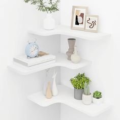 three white shelves with plants and vases on each shelf, one has an alarm clock