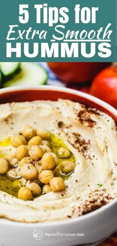 hummus in a bowl with olives and tomatoes on the side, text overlay reads 5 tips for extra smooth hummus