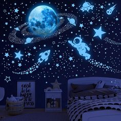 an image of a bedroom with stars and planets on the wall in the night sky