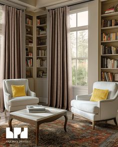 a living room with two chairs and a coffee table in front of a bookcase