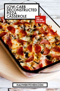 a pizza casserole with pepperoni and olives on it sitting on a cutting board