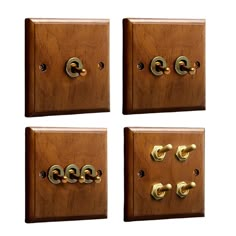 four wooden switch plates with brass knobs