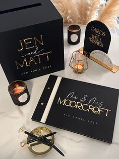 the wedding stationery is set up with candles and personalized guest books for guests