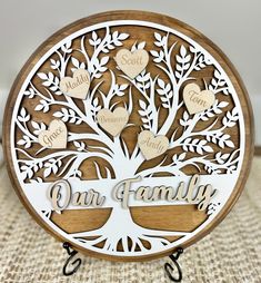 a family tree with hearts on it and the words our family engraved in white lettering