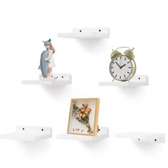 three shelves with figurines on them and an alarm clock