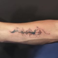 a person's arm with a sound wave tattoo on it