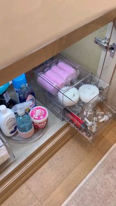 an open drawer in a bathroom filled with personal care items