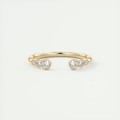 a gold ring with three diamonds on it