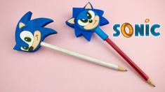 two sonic characters are next to a pencil and eraser on a pink background with the word sonic written below them