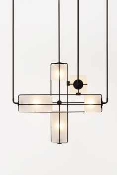 a chandelier with five lights hanging from it's center and four rectangular shades